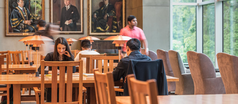 students spread out sitting at different tables in the Ridington Read Room